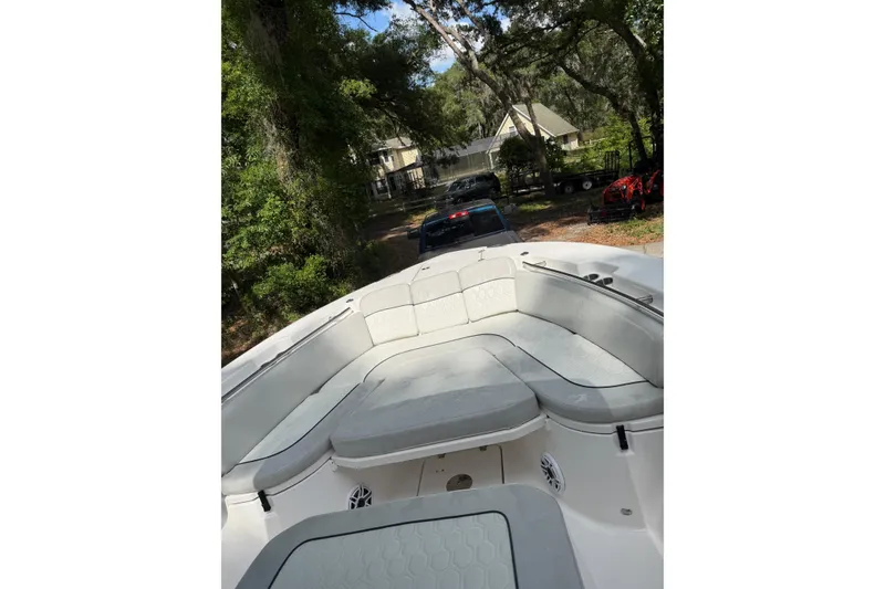Slide: The Image of 2023 Sea Fox 288 Commander boat interior with seating, parked in a wooded driveway. - 27