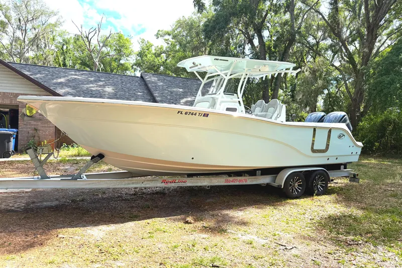 Slide: The Image of 2023 Sea Fox 288 Commander boat on trailer, parked outdoors near trees. - 5