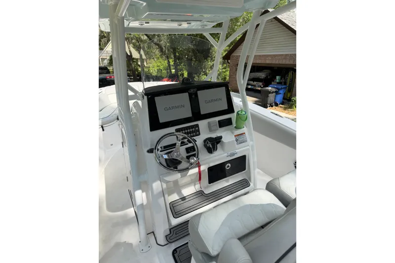 Slide: The Image of 2023 Sea Fox 288 Commander boat dashboard with Garmin displays and steering wheel. - 8