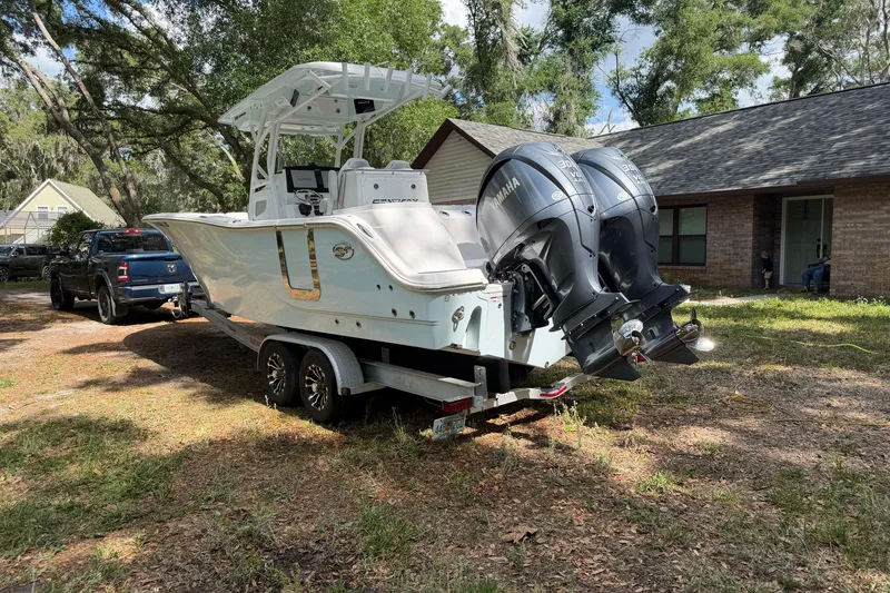 Slide: The Image of 2023 Sea Fox 288 Commander boat on trailer, parked outdoors near a house. - 9