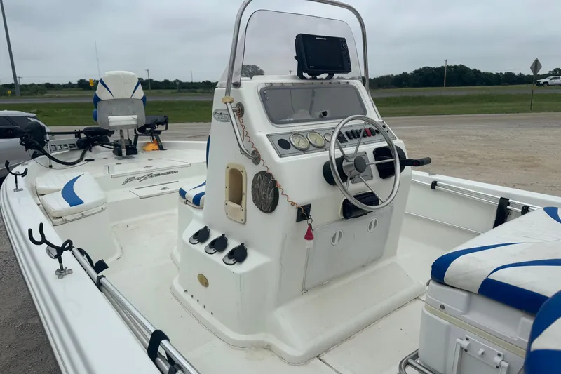 Slide: The Image of 2007 Bay Stealth 2230 boat interior with steering console and seating. - 4