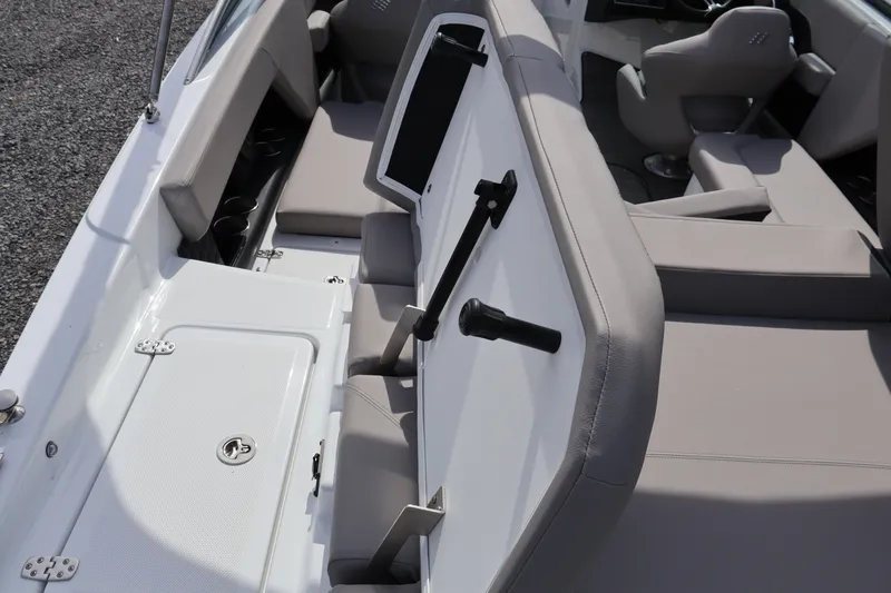 Slide: The Image of 2026 Four Winns H4 boat interior with gray seating and storage compartments. - 10