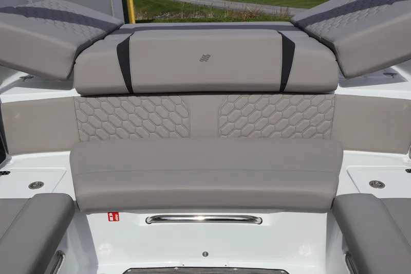 Slide: The Image of 2026 Four Winns H4 boat interior with gray cushioned seating and hexagonal stitching design. - 12