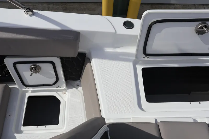 Slide: The Image of Interior view of 2026 Four Winns H4 boat, featuring storage compartments and seating. - 13