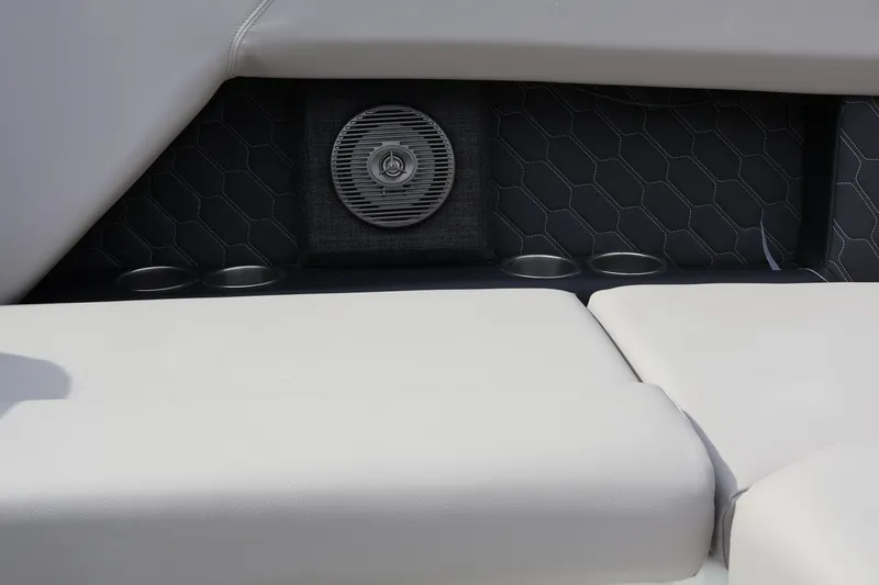 Slide: The Image of 2026 Four Winns H4 boat interior with speaker, cup holders, and cushioned seating. - 15