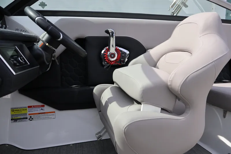 Slide: The Image of 2026 Four Winns H4 boat interior with steering wheel and beige captain's seat. - 18