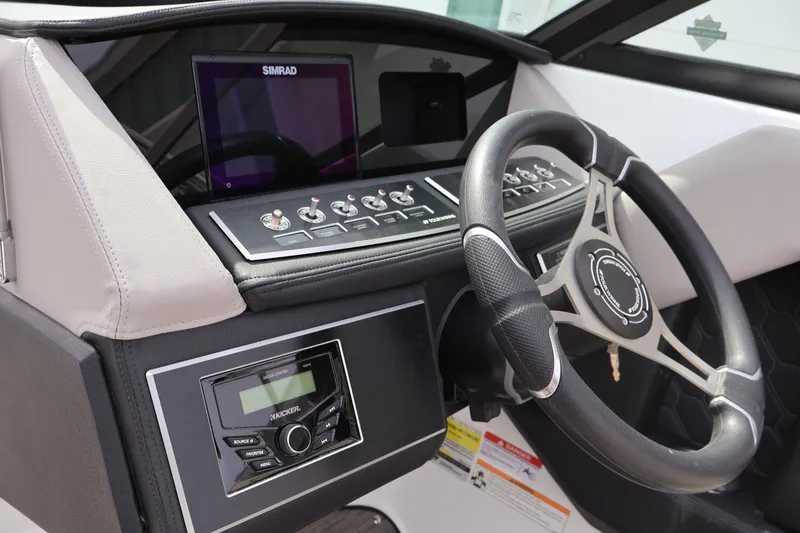 Slide: The Image of 2026 Four Winns H4 boat dashboard with steering wheel and control panel. - 19