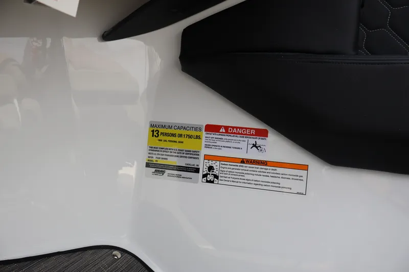 Slide: The Image of 2026 Four Winns H4 boat capacity and safety warning labels. - 20