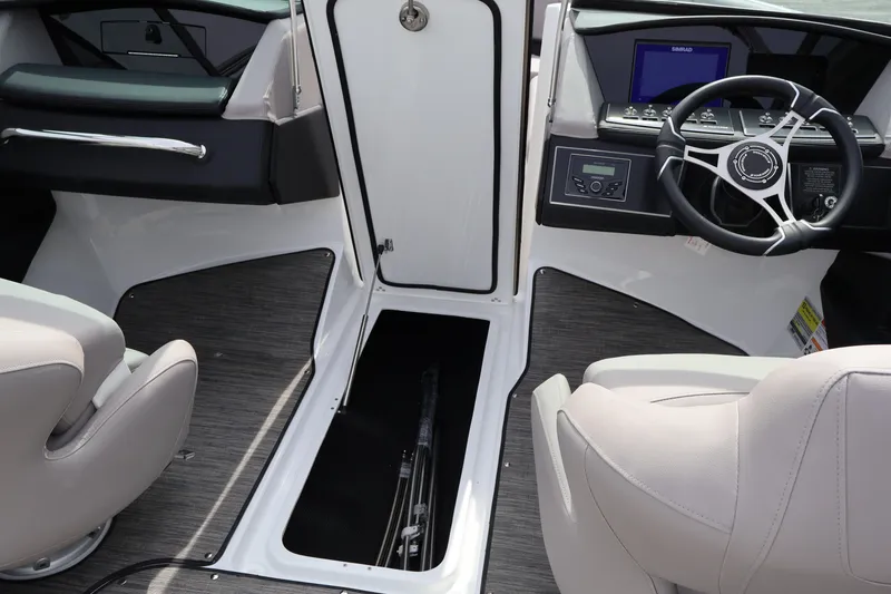 Slide: The Image of Interior of 2026 Four Winns H4 boat with steering wheel and seating. - 22