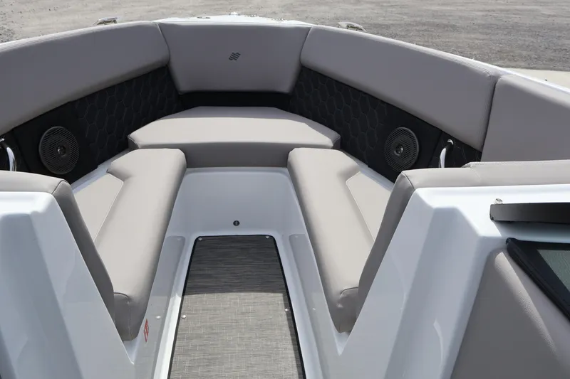 Slide: The Image of 2026 Four Winns H4 boat interior with gray cushioned seating and built-in speakers. - 25