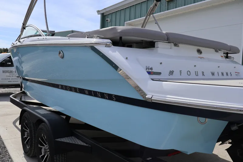 Slide: The Image of 2026 Four Winns H4 boat on trailer, showcasing sleek design and modern features. - 3