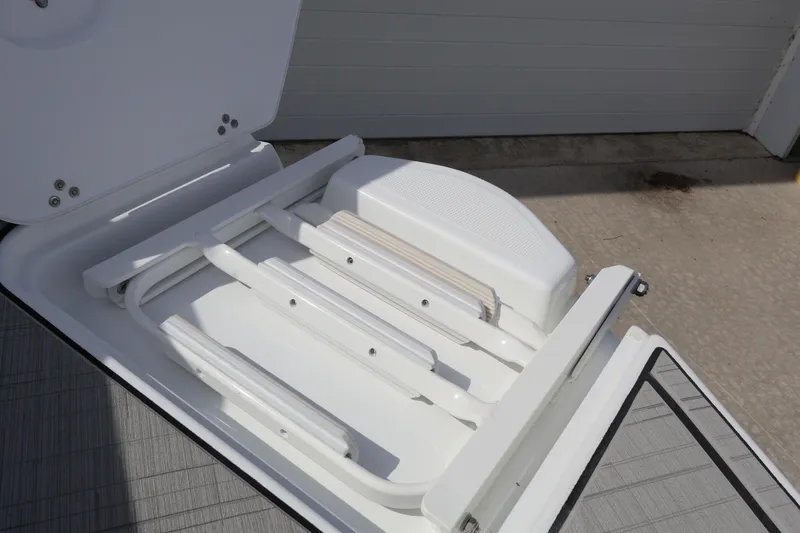 Slide: The Image of 2026 Four Winns H4 boat ladder compartment, open and ready for use. - 7