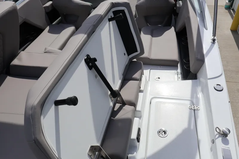 Slide: The Image of 2026 Four Winns H4 boat interior with gray seating and storage compartments. - 9