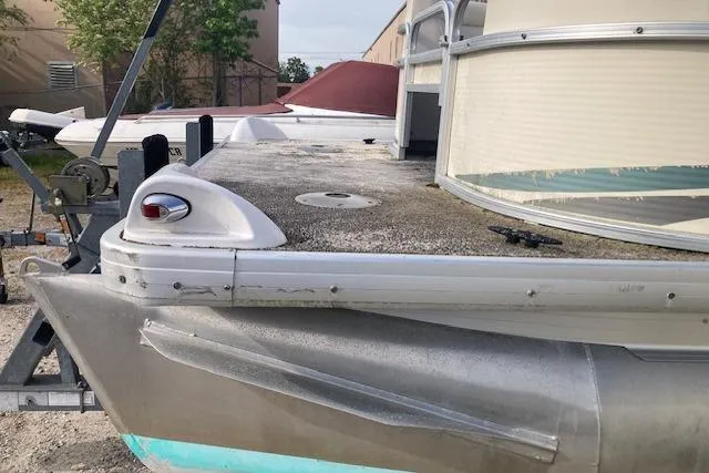 Slide: The Image of Pontoon boat Sweetwater Tuscany 2086, 2010 model, showing weathered deck and railing. - 12