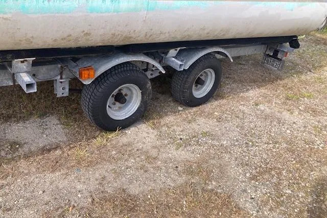 Slide: The Image of Trailer wheels of a 2010 Sweetwater Tuscany 2086 on a grassy surface. - 15