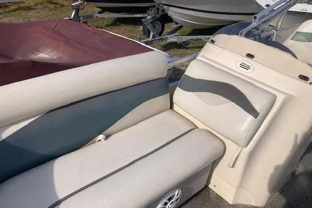 Slide: The Image of Sweetwater Tuscany 2086 boat interior, 2010 model, featuring beige and blue seating. - 7