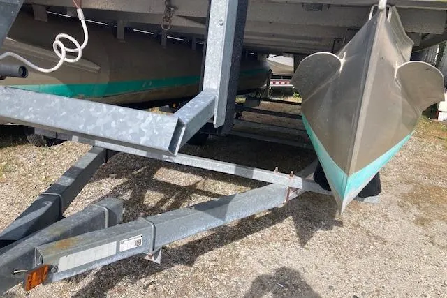 Slide: The Image of Pontoon boat on trailer, Sweetwater Tuscany 2086, 2010 model, parked on gravel. - 14