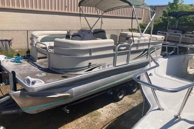 Slide: The Image of Pontoon boat Sweetwater Tuscany SWT 2080 REF 2010 on trailer, parked outdoors. - 16