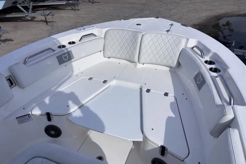 Slide: The Image of 2025 Sea Fox 228 Commander boat interior with white cushioned seating and cup holders. - 6