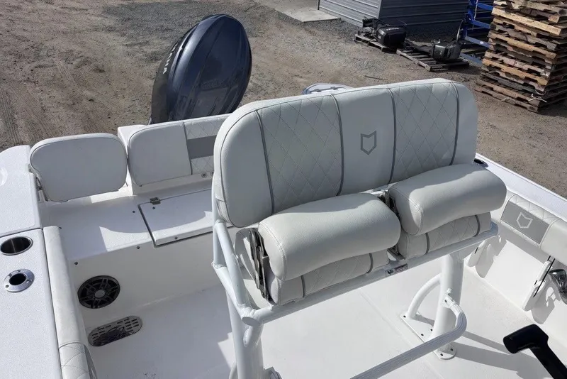 Slide: The Image of 2025 Sea Fox 228 Commander boat interior with cushioned seating and motor. - 7