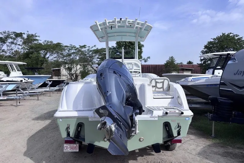 Slide: The Image of 2025 Sea Fox 228 Commander boat with outboard motor, parked in a marina. - 8