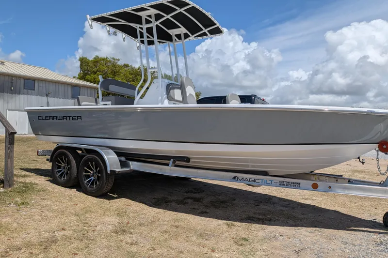 Slide: The Image of 2026 Clearwater 21 Bay boat on trailer under blue sky. - 2