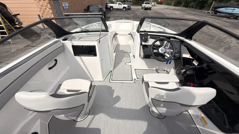 Slide: The Image of The image shows the cockpit of a 2026 Yamaha AR220 boat with two white seats and a modern helm. - 22
