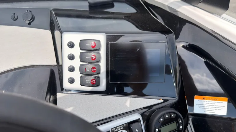 Slide: The Image of The image shows the dashboard of a Yamaha AR220 boat with modern controls and a display. - 28