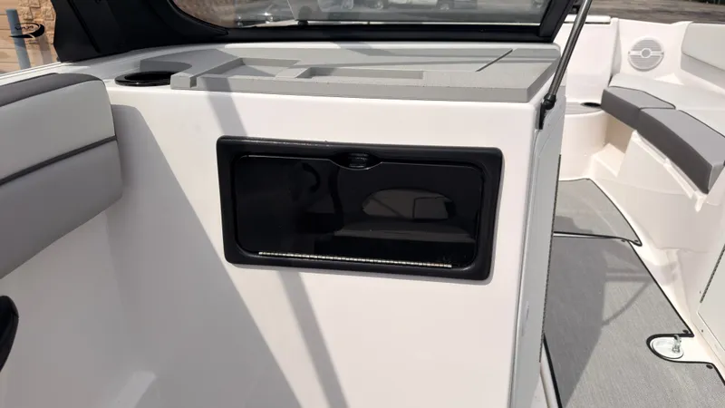 Slide: The Image of Interior view of a Yamaha AR220 boat with gray upholstery and a black storage compartment. - 23