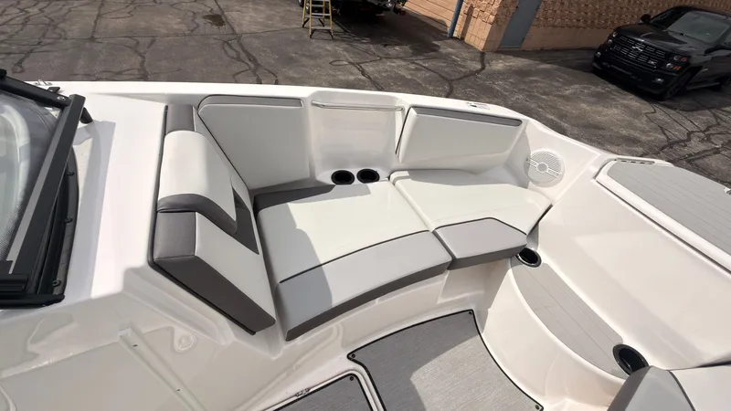 Slide: The Image of The image shows the bow area of a Yamaha AR220 boat with white and gray upholstery. - 35