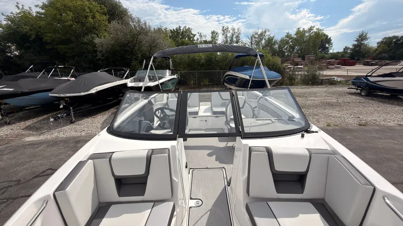 Slide: The Image of The image shows a 2026 Yamaha AR220 boat with modern seating and a clear sky. - 39