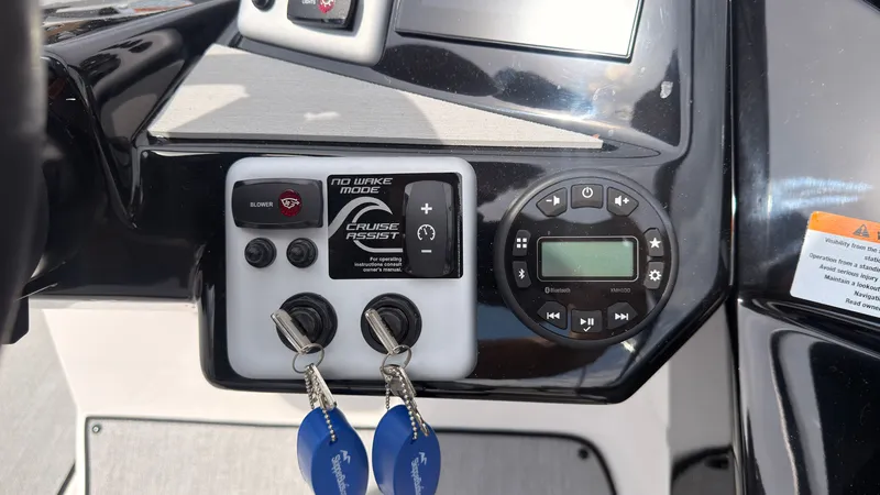 Slide: The Image of The image shows the dashboard of a Yamaha AR220 boat with various controls and keys. - 29