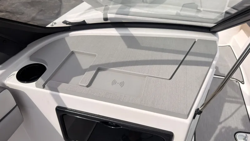 Slide: The Image of The image shows the cockpit of a 2026 Yamaha AR220 with a cup holder and charging station. - 25