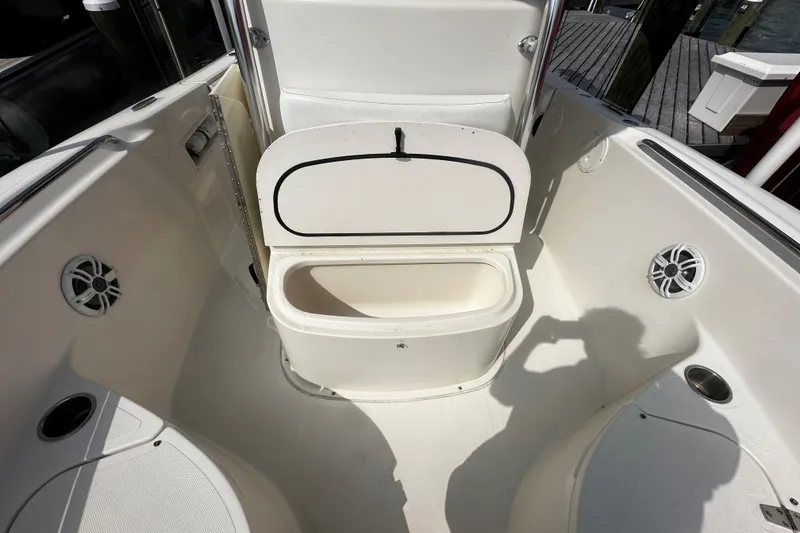 Slide: The Image of 2006 Pursuit 2570 Center Console boat interior with open storage compartment and speakers. - 10