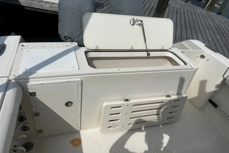 Slide: The Image of Open storage compartment on a 2006 Pursuit 2570 Center Console boat. - 3