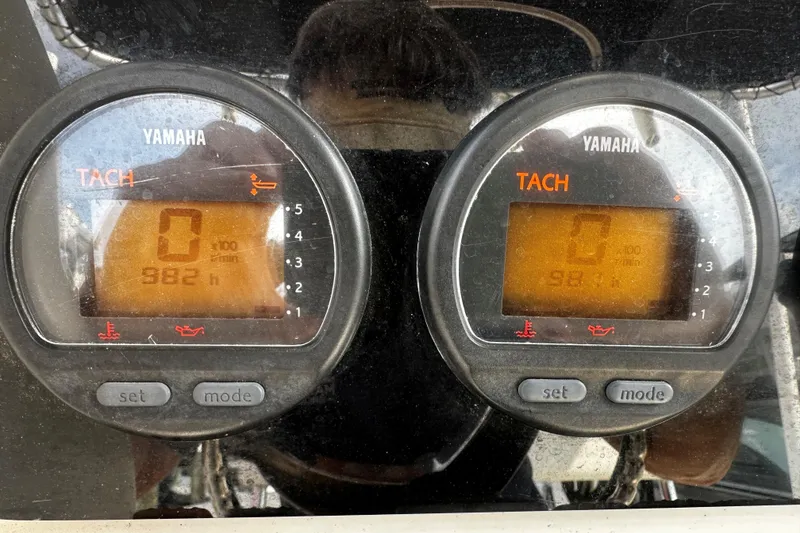 Slide: The Image of Yamaha tachometers on a 2006 Pursuit 2570 Center Console boat, displaying engine hours. - 8