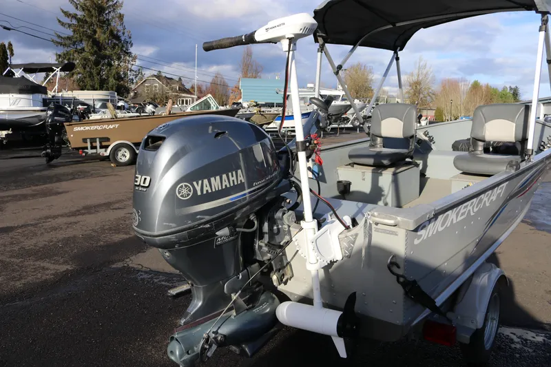 Slide: The Image of 2016 Smoker Craft Alaskan 15 boat with Yamaha 30 outboard motor, parked outdoors. - 3