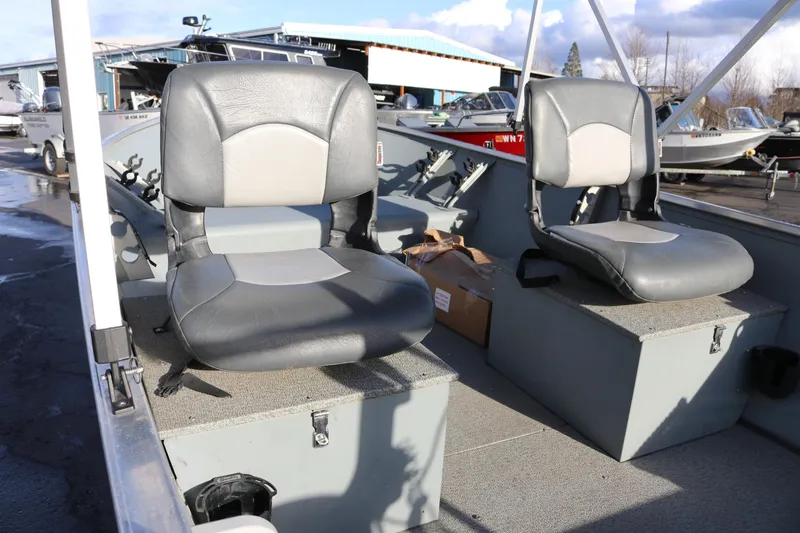 Slide: The Image of 2016 Smoker Craft Alaskan 15 boat interior with two gray seats. - 4