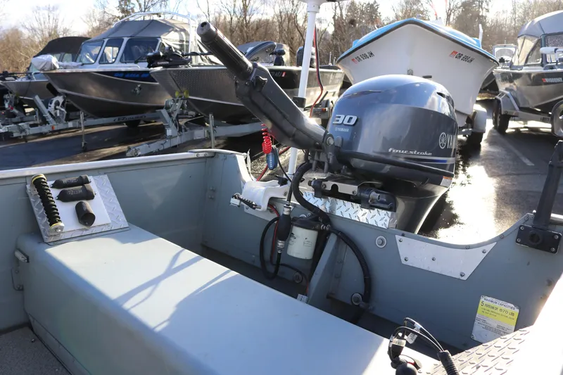 Slide: The Image of 2016 Smoker Craft Alaskan 15 boat with Yamaha 30 horsepower engine in a marina. - 5