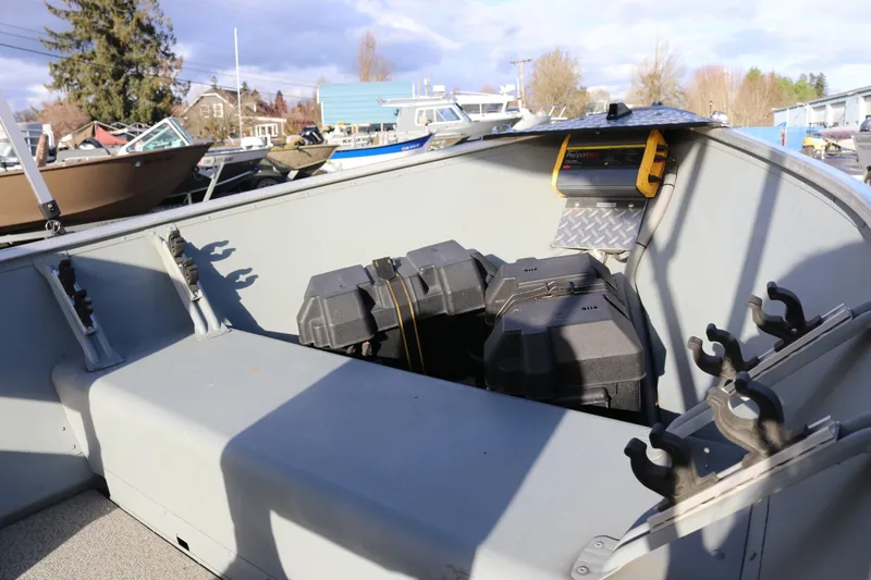 Slide: The Image of 2016 Smoker Craft Alaskan 15 boat interior with storage compartments and rod holders. - 6
