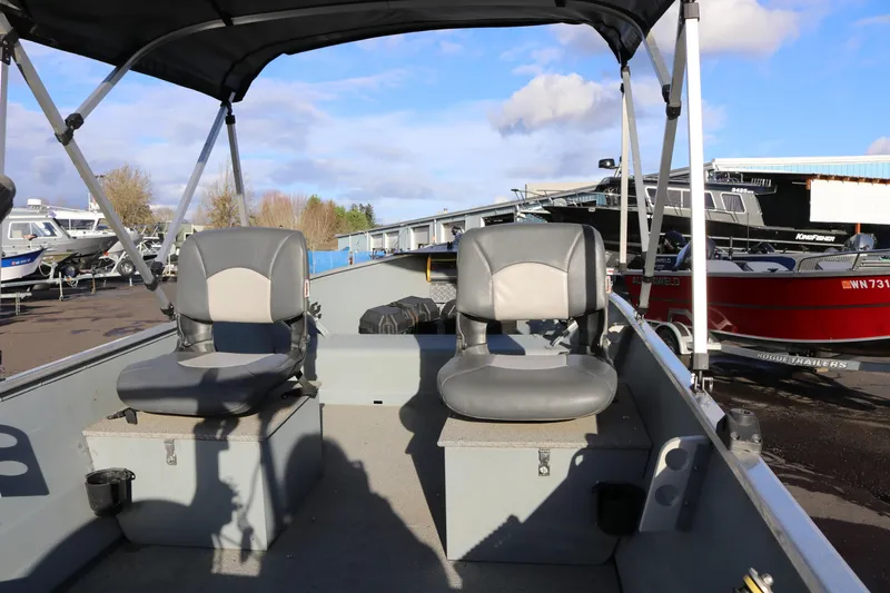 Slide: The Image of 2016 Smoker Craft Alaskan 15 boat interior with two seats and canopy. - 8