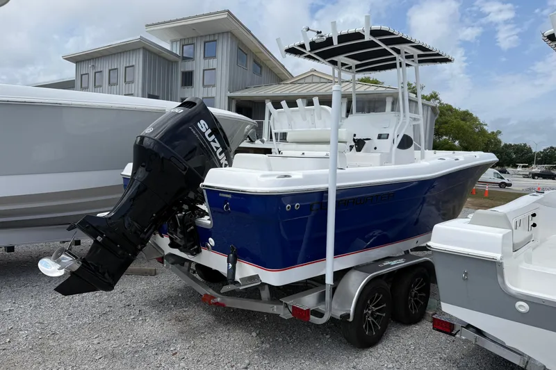 Slide: The Image of 2026 Clearwater 2200 Center Console boat with Suzuki outboard motor on trailer. - 2