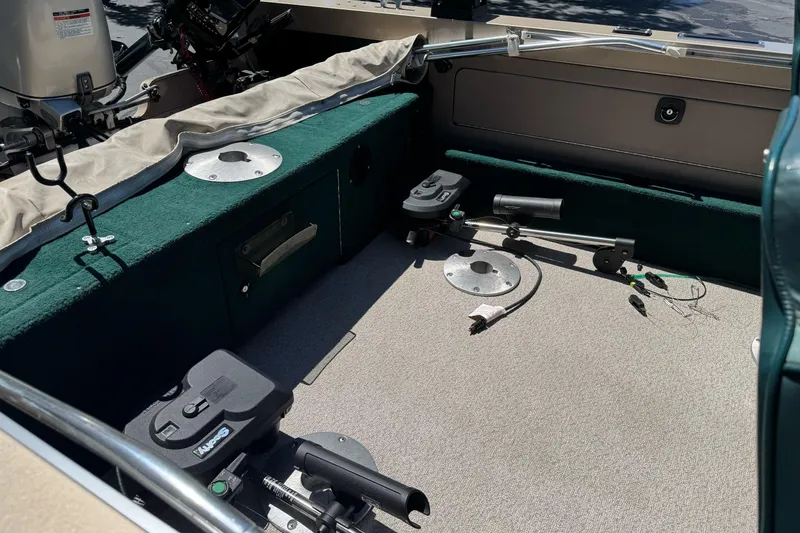 Slide: The Image of Interior of a 2000 Lund 1600 Pro Sport boat with fishing equipment. - 18