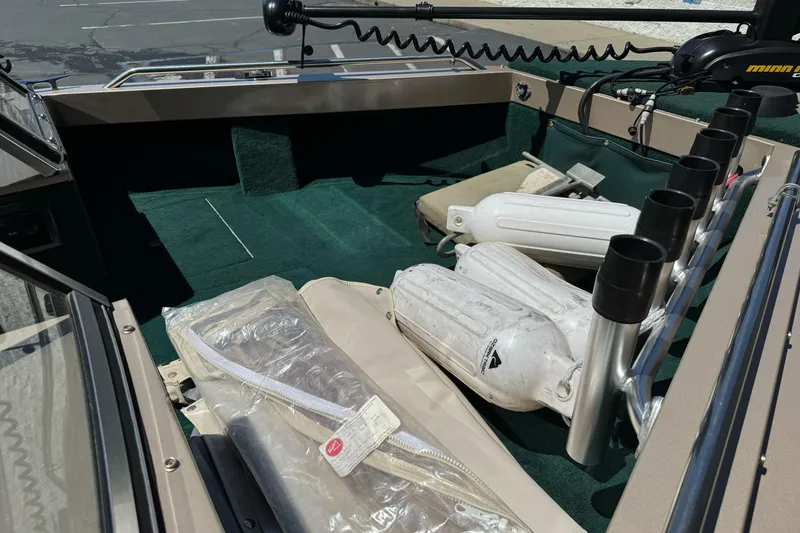 Slide: The Image of Interior of a 2000 Lund 1600 Pro Sport boat with fishing rod holders and equipment. - 19