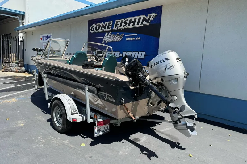 Slide: The Image of 2000 Lund 1600 Pro Sport boat with Honda outboard motor on trailer. - 4