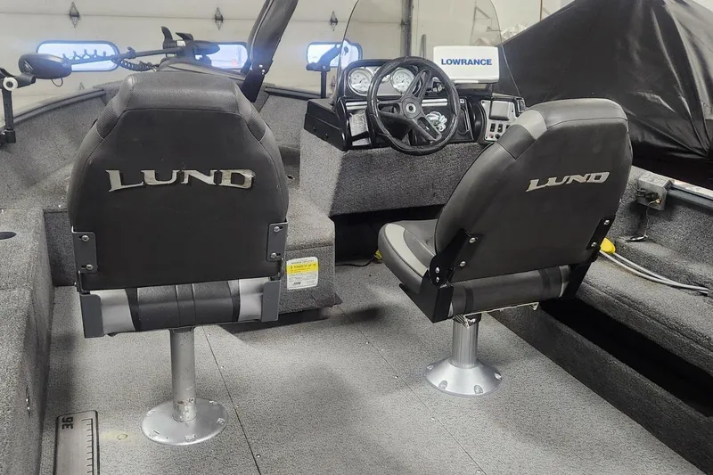Slide: The Image of 2018 Lund 1650 Rebel XS Tiller boat interior with steering console and seats. - 13