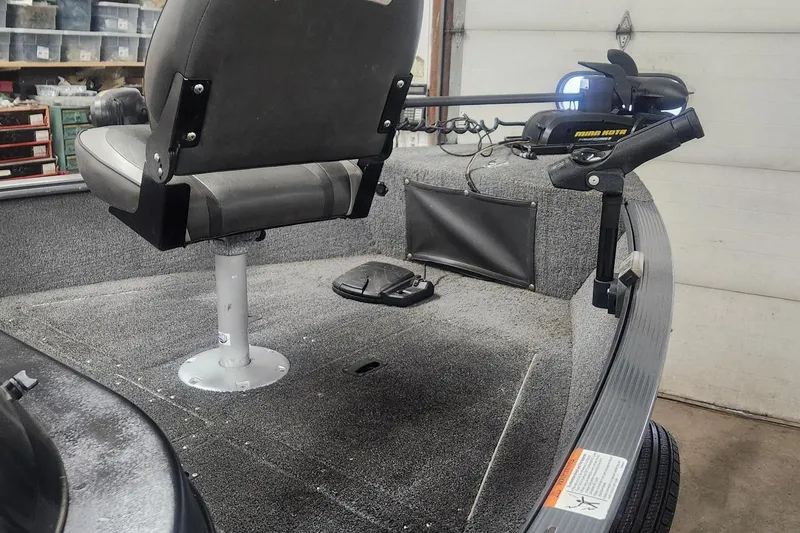 Slide: The Image of 2018 Lund 1650 Rebel XS Tiller boat interior with seat and trolling motor. - 2