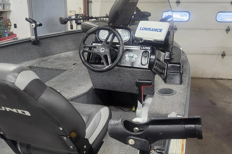 Slide: The Image of 2018 Lund 1650 Rebel XS Tiller boat interior with steering wheel and Lowrance equipment. - 3