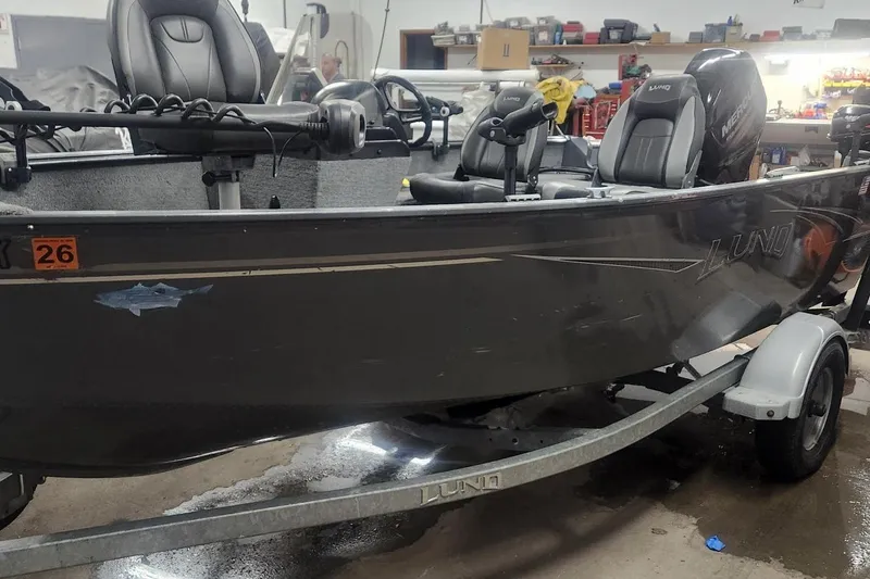 Slide: The Image of 2018 Lund 1650 Rebel XS Tiller boat in a garage setting. - 6