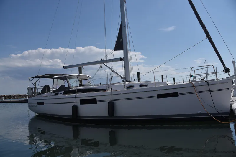 Slide: The Image of 2023 Catalina 425 sailboat docked in a marina under a clear blue sky. - 1